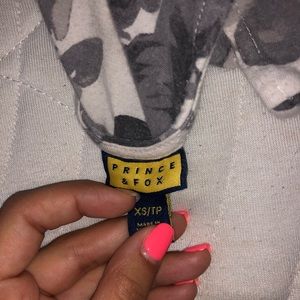 a gray and white floral pattern shirt